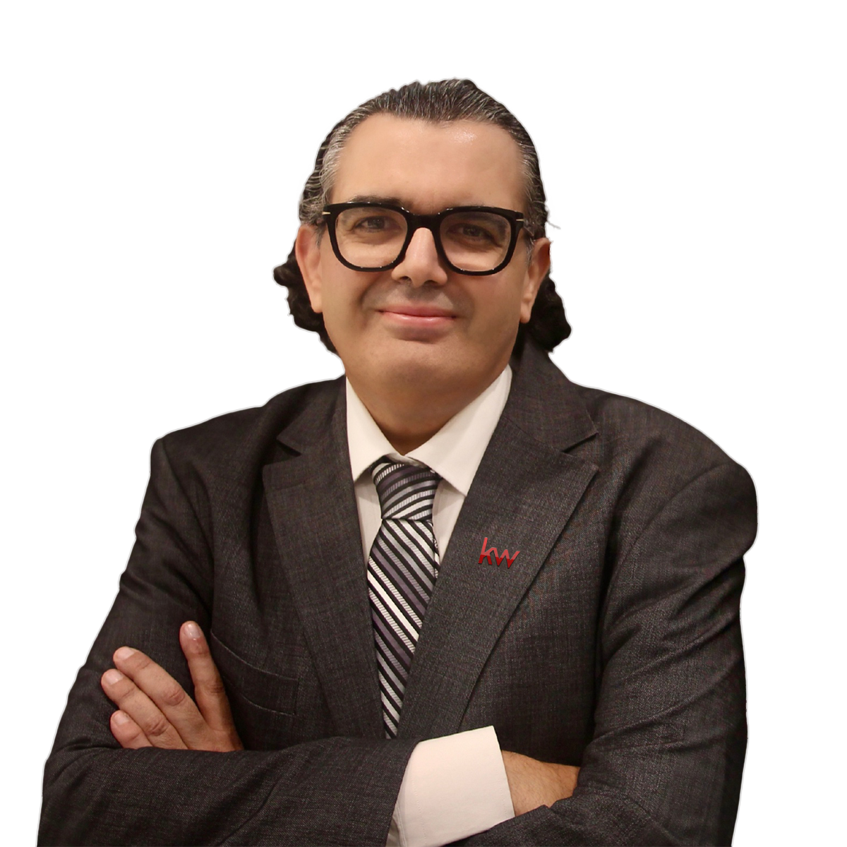 Mohamad Itani, business professional in a suit, smiling confidently with arms crossed.